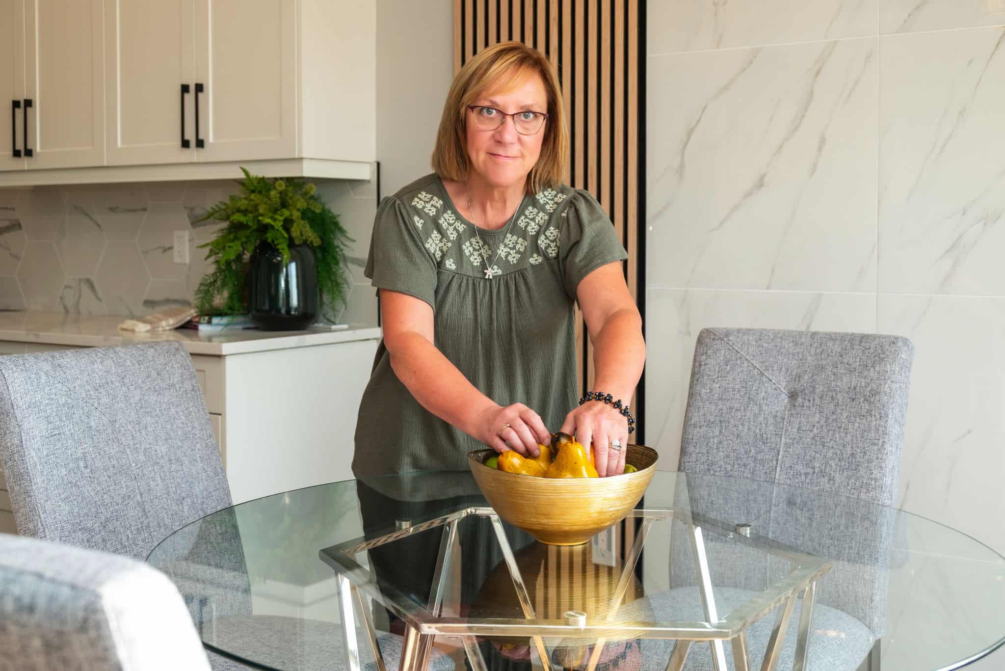 Connect with Us 1 Leigh fixing a bowl of fruit on dining table Edmonton real estate